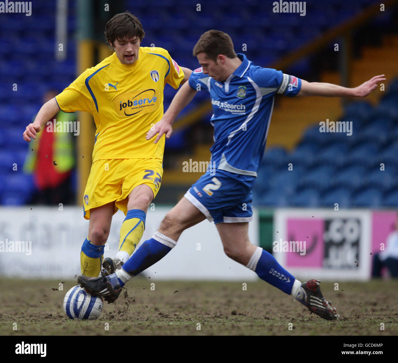 Colchester United's Anthony Wordsworth (left) and Stockport County's Johnny Mullins (right) battle for the ball during the Coca-Cola League One match at Edgeley Park, Stockport. Stock Photo
