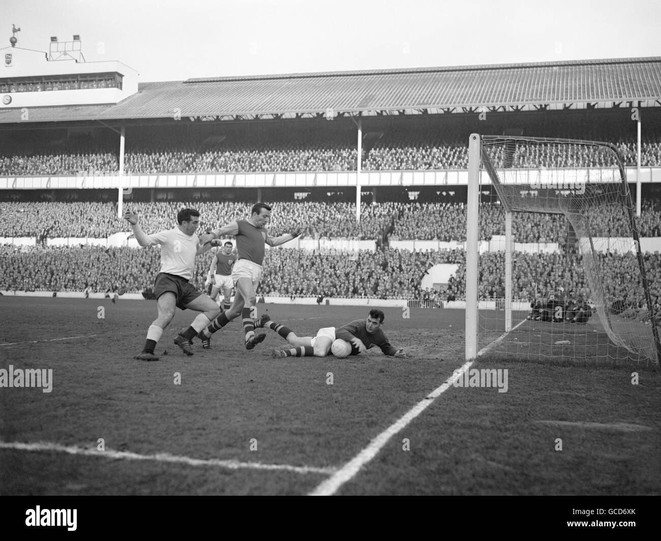 Adam Blacklaw, Burnley goalkeeper, saves the from Spurs' John Smith, and from his own centre half John Talbut. Stock Photo