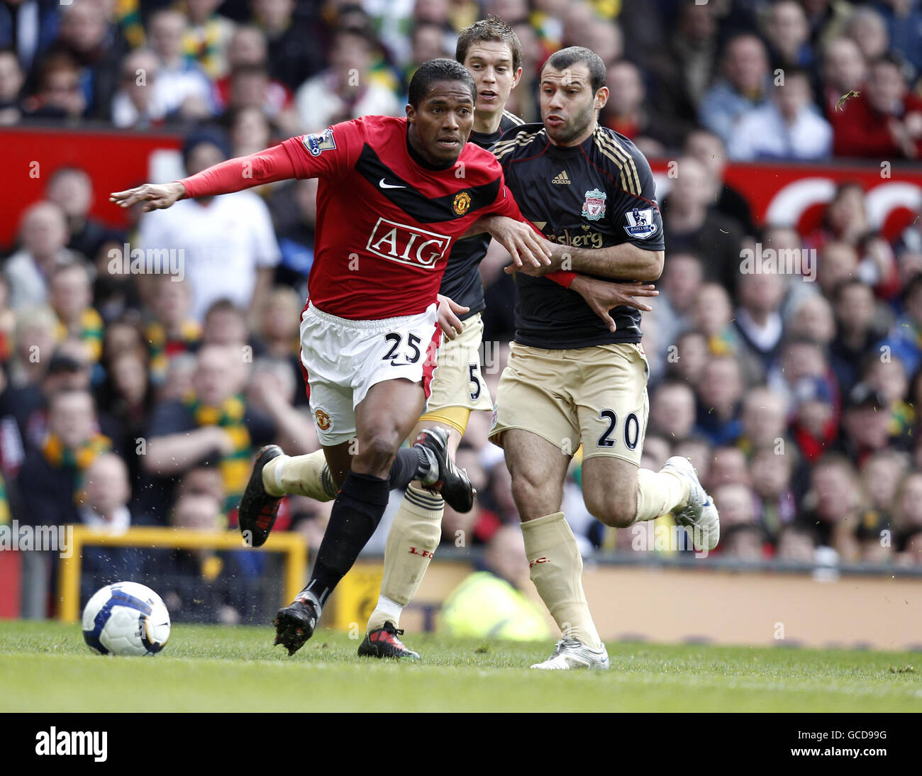 Manchester United's Antonio Valencia (left) and Liverpool's Javier Mascherano in action during the Barclays Premier League match at Old Trafford, Manchester. Stock Photo