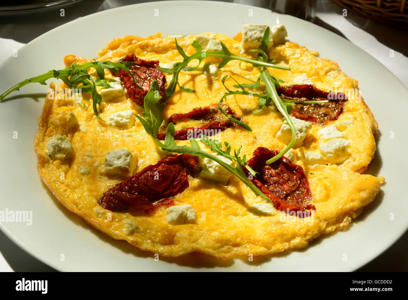 Omelette with sun dried tomatoes Stock Photo Alamy