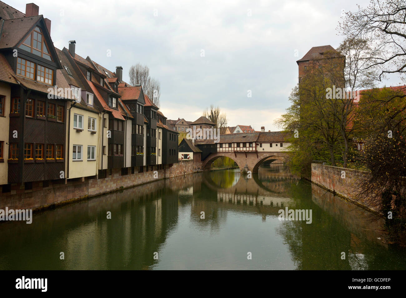 Historic buildings on Pegnitz riverside and covered bridge in Nuremberg old town district Stock Photo