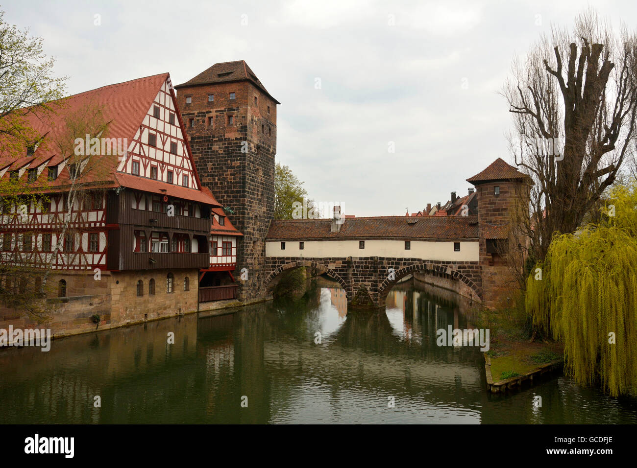 Historic buildings on the bank of Pegnitz river and covered bridge in Nuremberg old town district Stock Photo