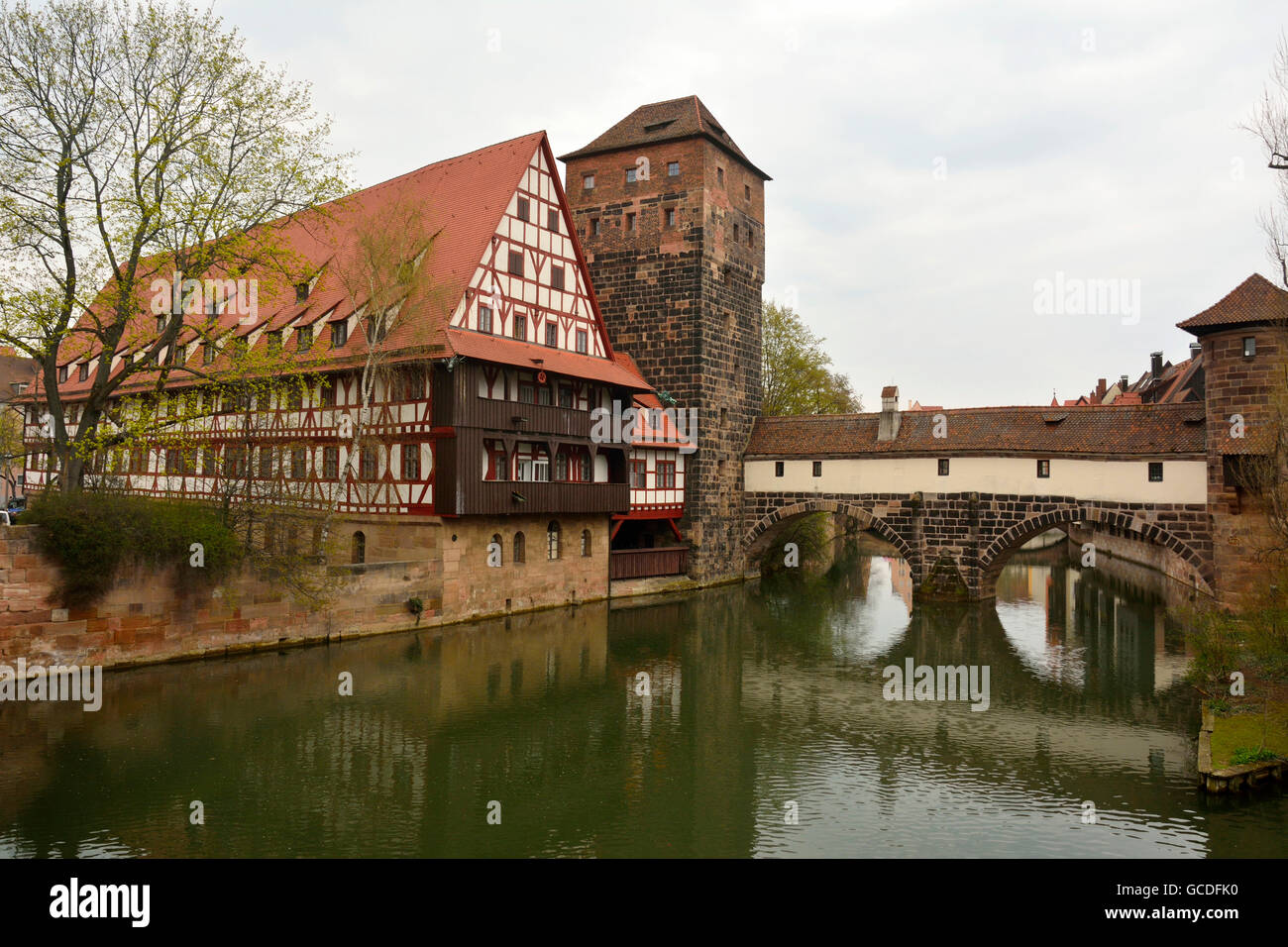 Historic buildings on Pegnitz riverside and covered bridge in Nuremberg old town district. Stock Photo