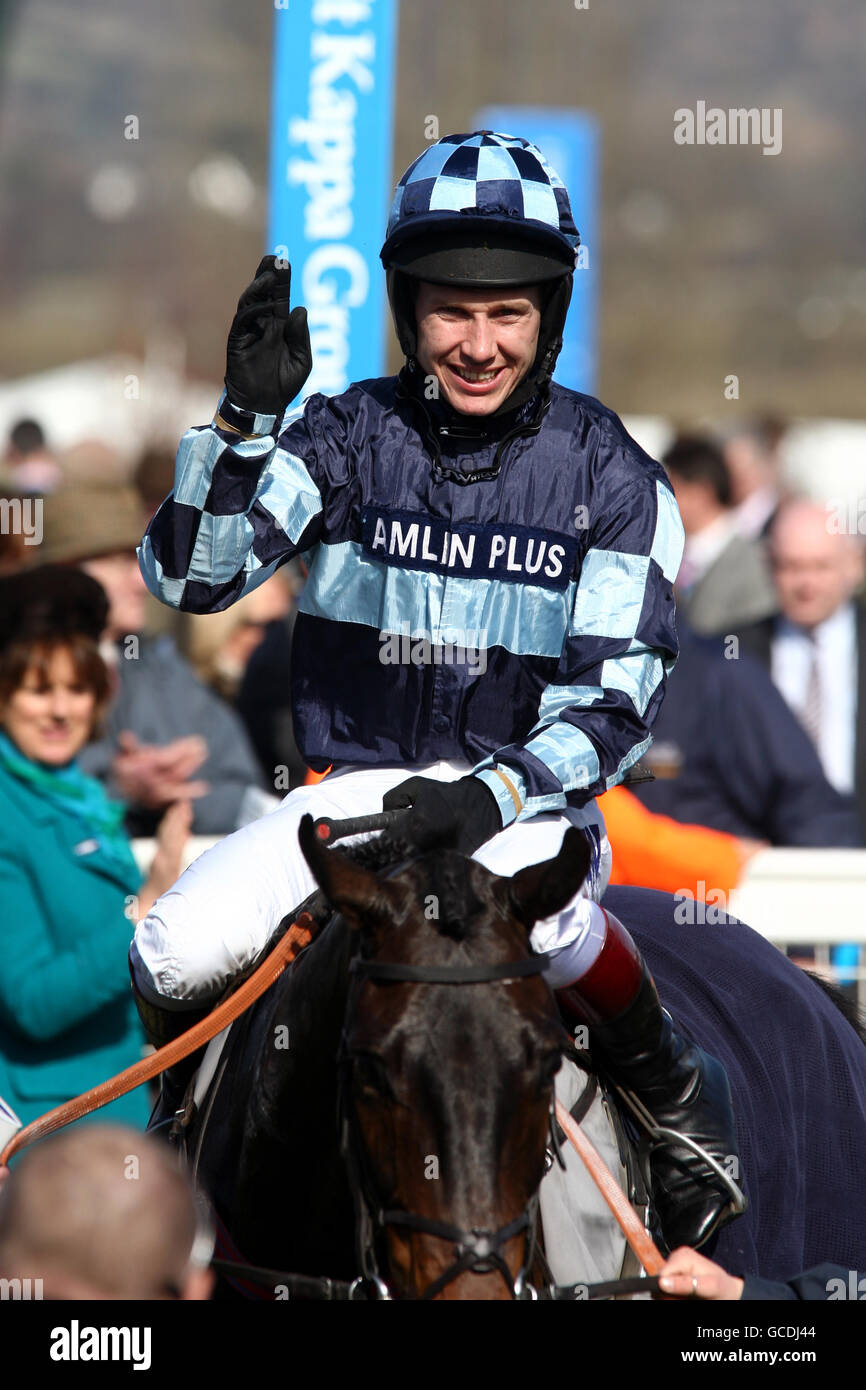 Menorah ridden by Richard Johnson celebrates winning the Spinal Research Supreme Novices' Hurdle during day one of the 2010 Cheltenham Festival at Cheltenham Racecourse. Stock Photo