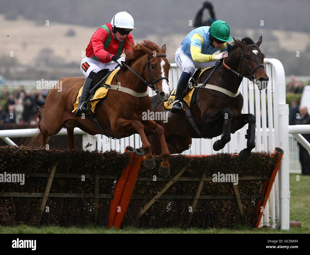 Blazing Buck ridden by Lee Edwards (left) and Westlin' Winds ridden by Oliver Greenall during the JCB Triumph Hurdle Stock Photo