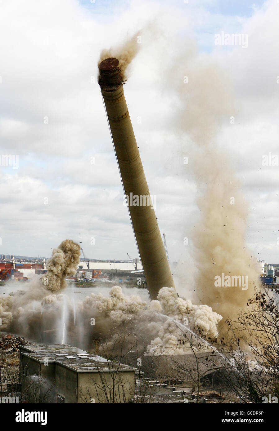 Two 550ft chimneys, which have dominated the Gravesham skyline for 40 years, come crashing down at Lafarge Cement's Northfleet site in Kent, marking the end of nearly 200 years of cement production at the site. Stock Photo