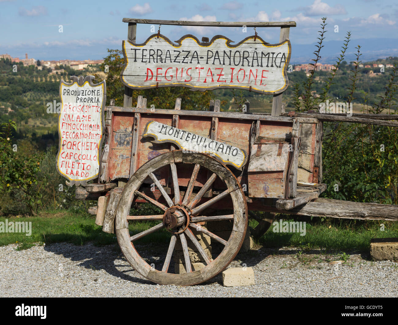 A wooden cart with numerous signs in Italian; Gaiole in Chianti, Toscana, Italy Stock Photo