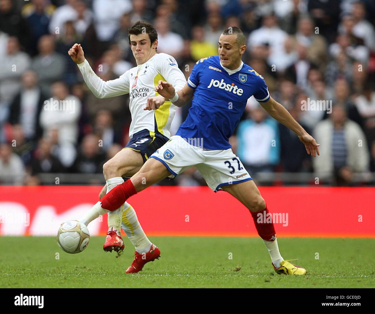 Soccer - FA Cup - Semi Final - Tottenham Hotspur v Portsmouth - Wembley Stadium. Tottenham Hotspur's Gareth Bale (left) and Portsmouth's Hassan Yebda (right) battle for the ball. Stock Photo