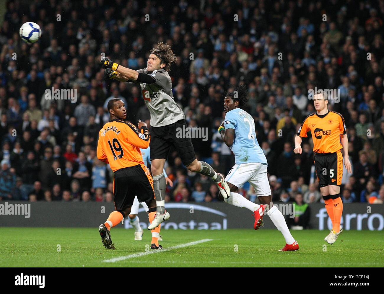 Soccer - Barclays Premier League - Manchester City v Wigan Athletic - City of Manchester Stadium. Wigan Athletic goalkeeper Vladimir Stojkovic (second left) jumps highest to clear the ball Stock Photo