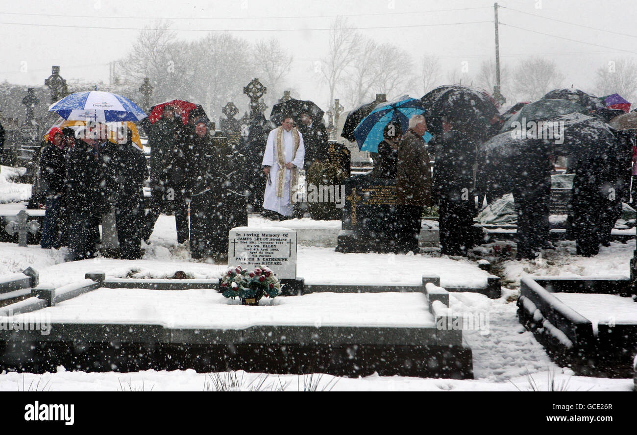 People disperse after a funeral at Killygarry Parish Church as heavy snow fell in Cavan town, Ireland. Stock Photo