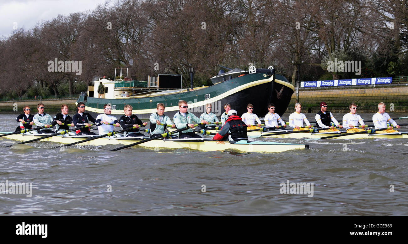 The Cambridge University boat race crew (boat on left) (left to right: Rob Weitemeyer, Geoff Roth, George Nash, Peter McClelland, captain Deaglan McEachern, Henry Pelly, Derek Rasmussen, Fred Gill and cox Ted Randolph) row past the Cambridge second team 'Goldie' during the training session on the River Thames, London. Stock Photo