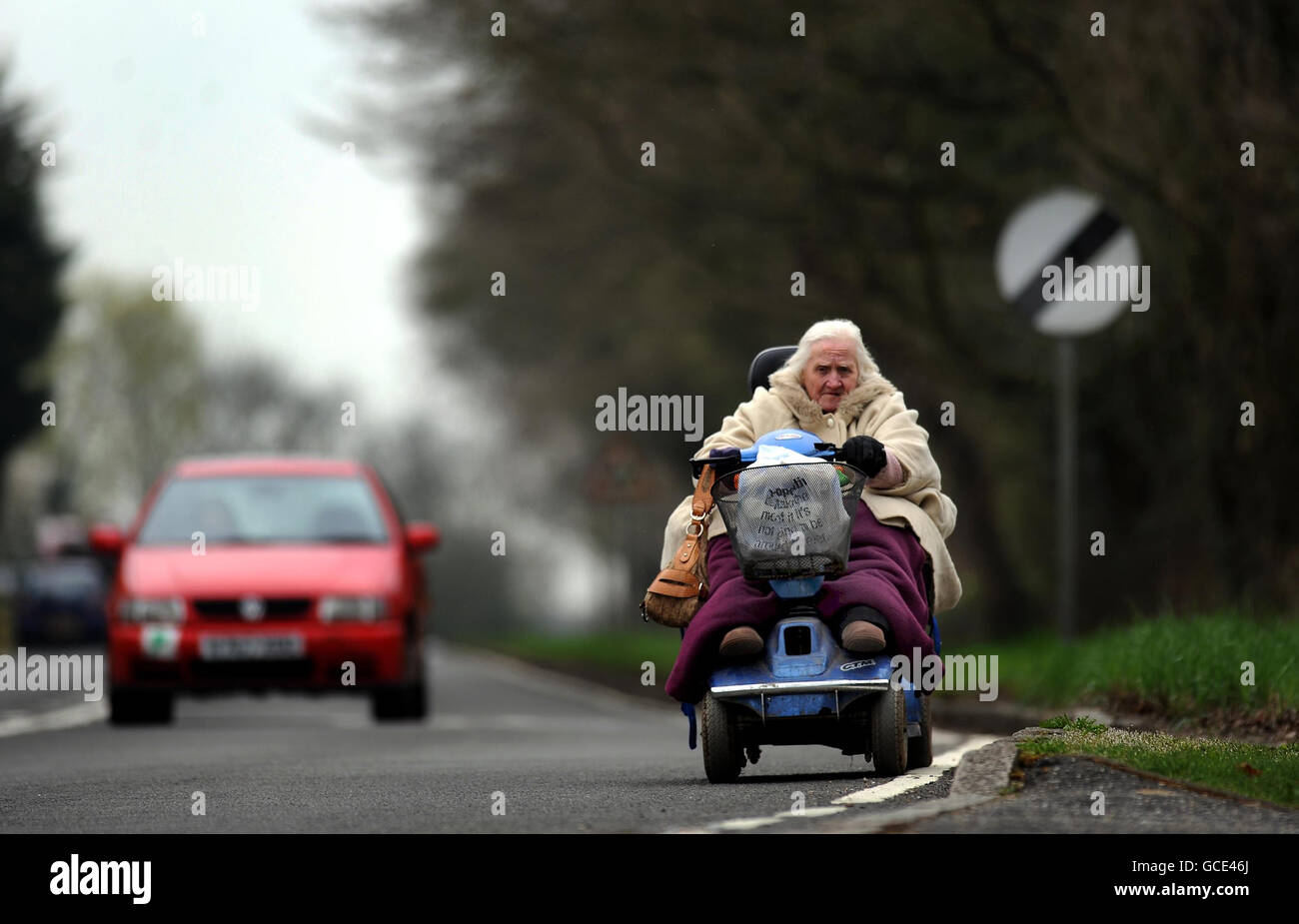 Mobility scooter rules. An elderly woman drives a mobility scooter