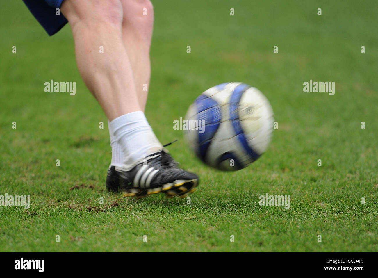Detail of a match ball being kicked during the warm up Stock Photo