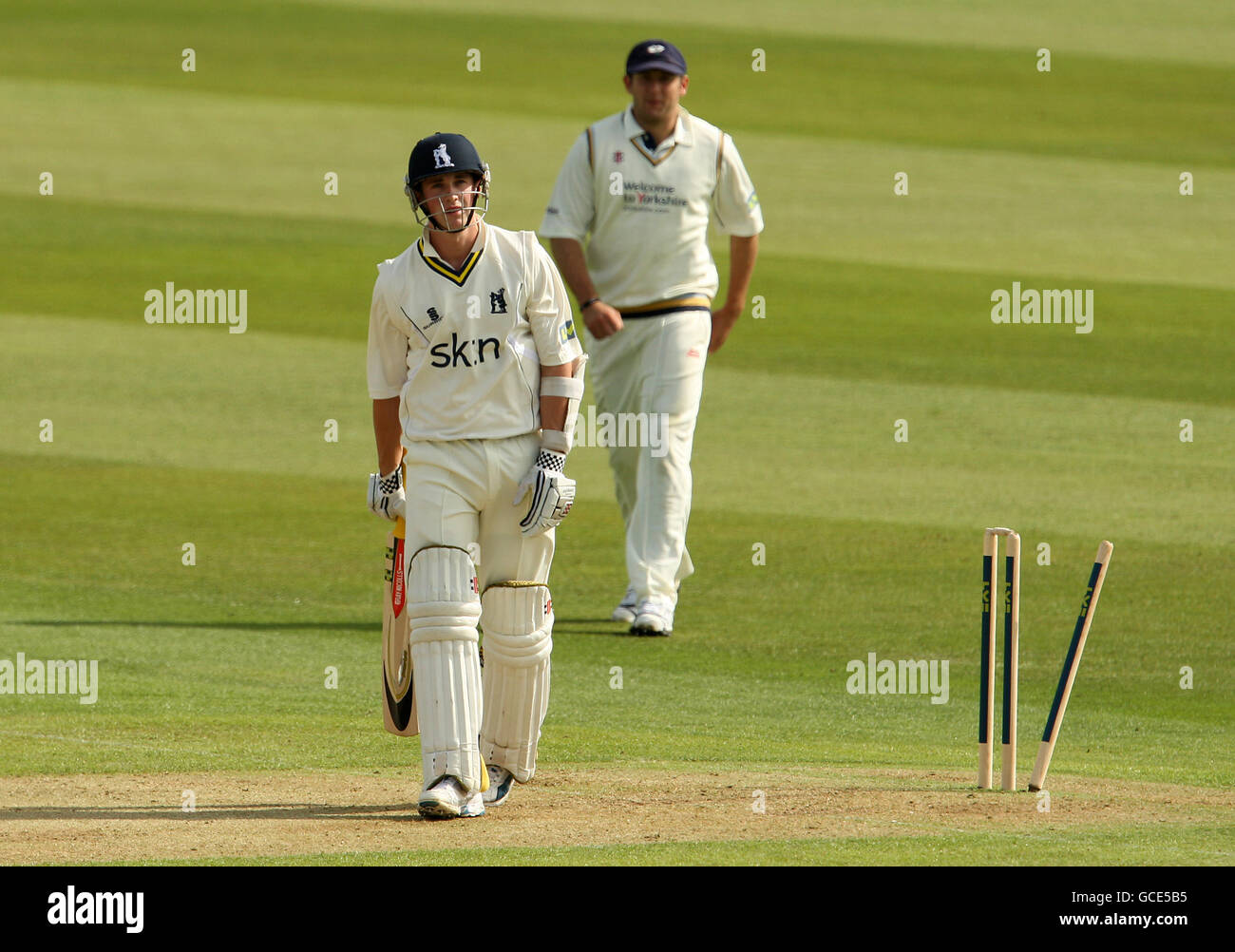 Warwickshire's Chris Woakes walks away dejected after seing his broken wicket bowled by Yorkshire's Steven Patterson Stock Photo