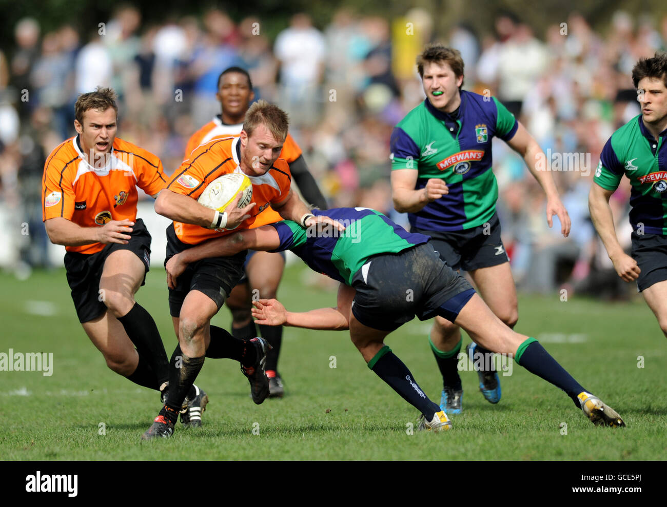 University of Johannesburg's Juan Swanepoel is tackled by Boroughmuir's Malcolm Clapperton during the Gibraltar Asset Management Melrose Sevens Stock Photo