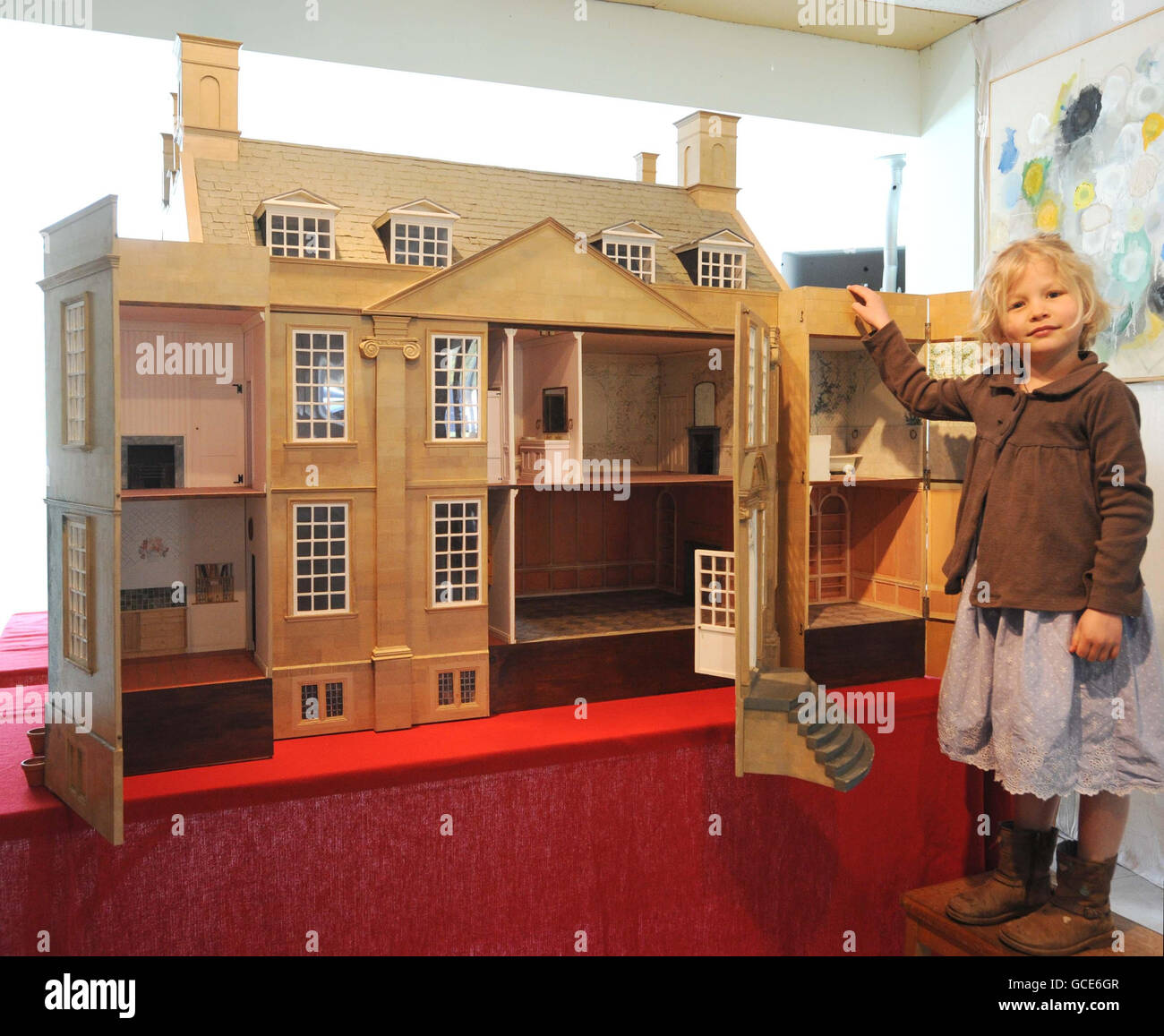 Emilia Hampton, who celebrated her 6th birthday today, with a 1:12th scale doll's house, modelled on Bourton House. The 24-room doll's house, which replicates the lavish interior of the celebrated country manor, is expected to fetch up to 3,000 at auction. Stock Photo