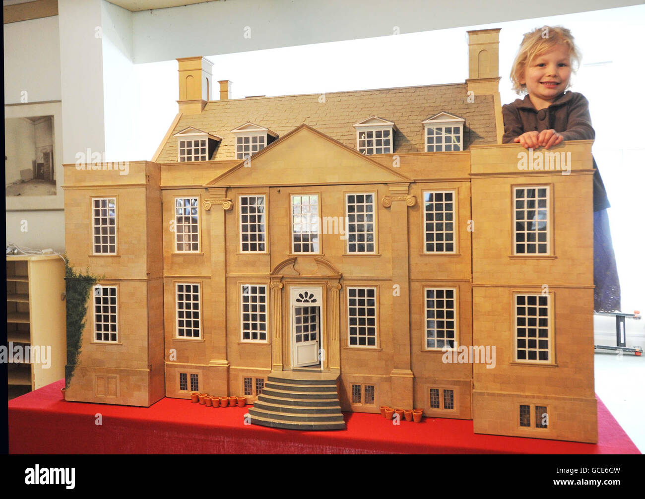 Emilia Hampton, who celebrated her 6th birthday today, with a 1:12th scale doll's house, modelled on Bourton House. The 24-room doll's house, which replicates the lavish interior of the celebrated country manor, is expected to fetch up to 3,000 at auction. Stock Photo