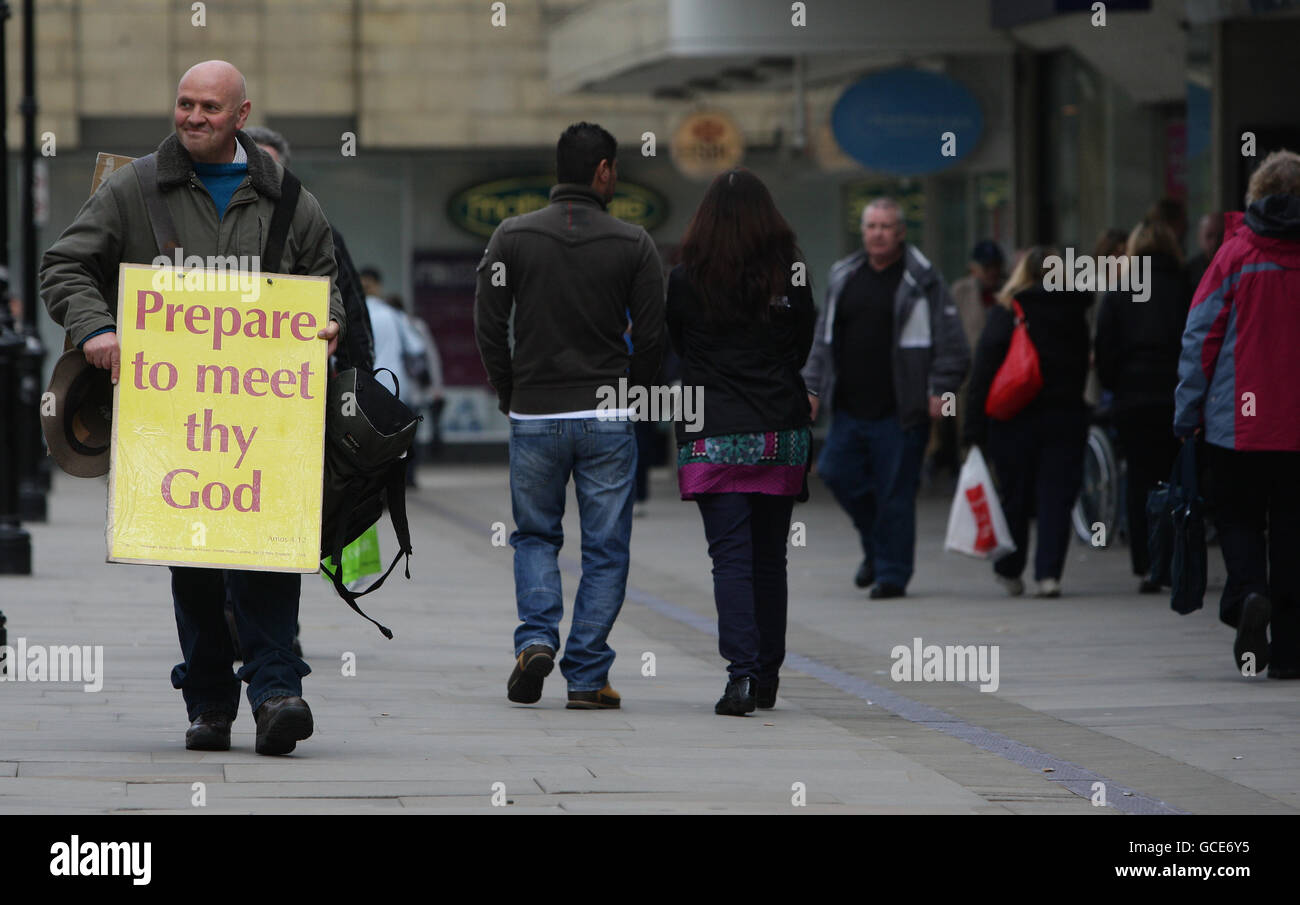 Bolton general views. A man wearing a sandwich board walks amongst shoppers in Bolton town centre. Stock Photo