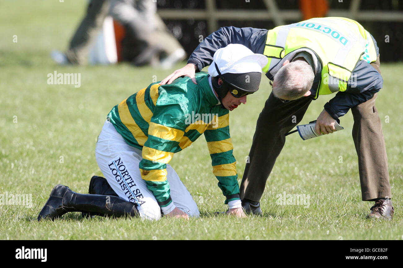 Larks Lad rider Barry Geraghty receives treatment after falling in the Artemis, The Profit Hunter Supporting Poppyscotland Novices' Handicap Hurdle during the Coral Scottish Grand National Festival at Ayr Racecourse, Ayr. Stock Photo