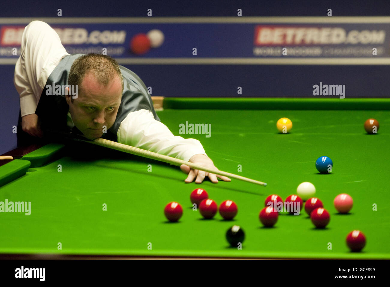 John Higgins in action against Barry Hawkins during the Betfred World Snooker Championships at the Crucible Theatre, Sheffield Stock Photo