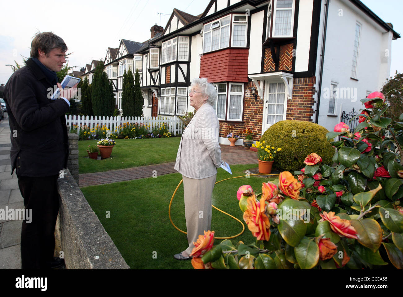 Conservative parliamentary candidate Zac Goldsmith speaks to local resident Elizabeth Delahuntly as he campaigns in Tudor near Kingston upon Thames, south west London, ahead of the General Election on May 6. Stock Photo