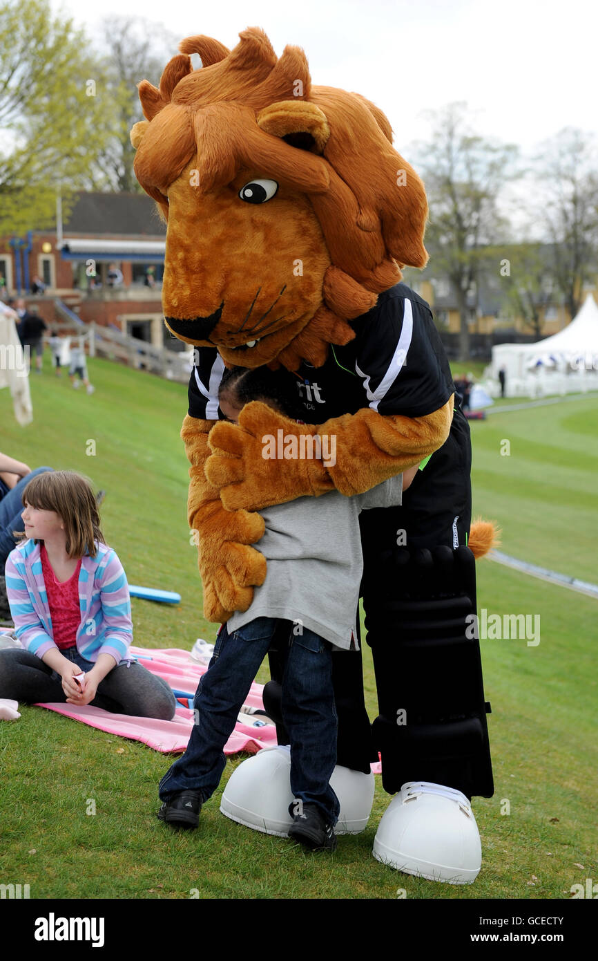 Surrey mascot caesar the lion with a young fan hires stock photography
