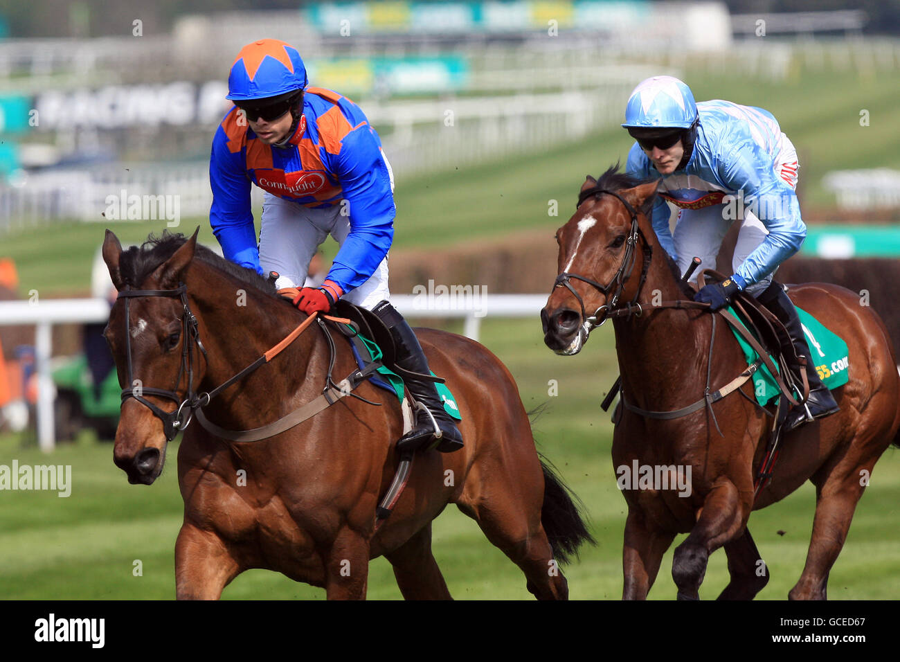 Twist Magic (left) ridden by jockey Sam Thomas leads from I'm So Lucky ridden by jockey Tom Scudamore during The bet365.com Celebration Steeple Chase Stock Photo