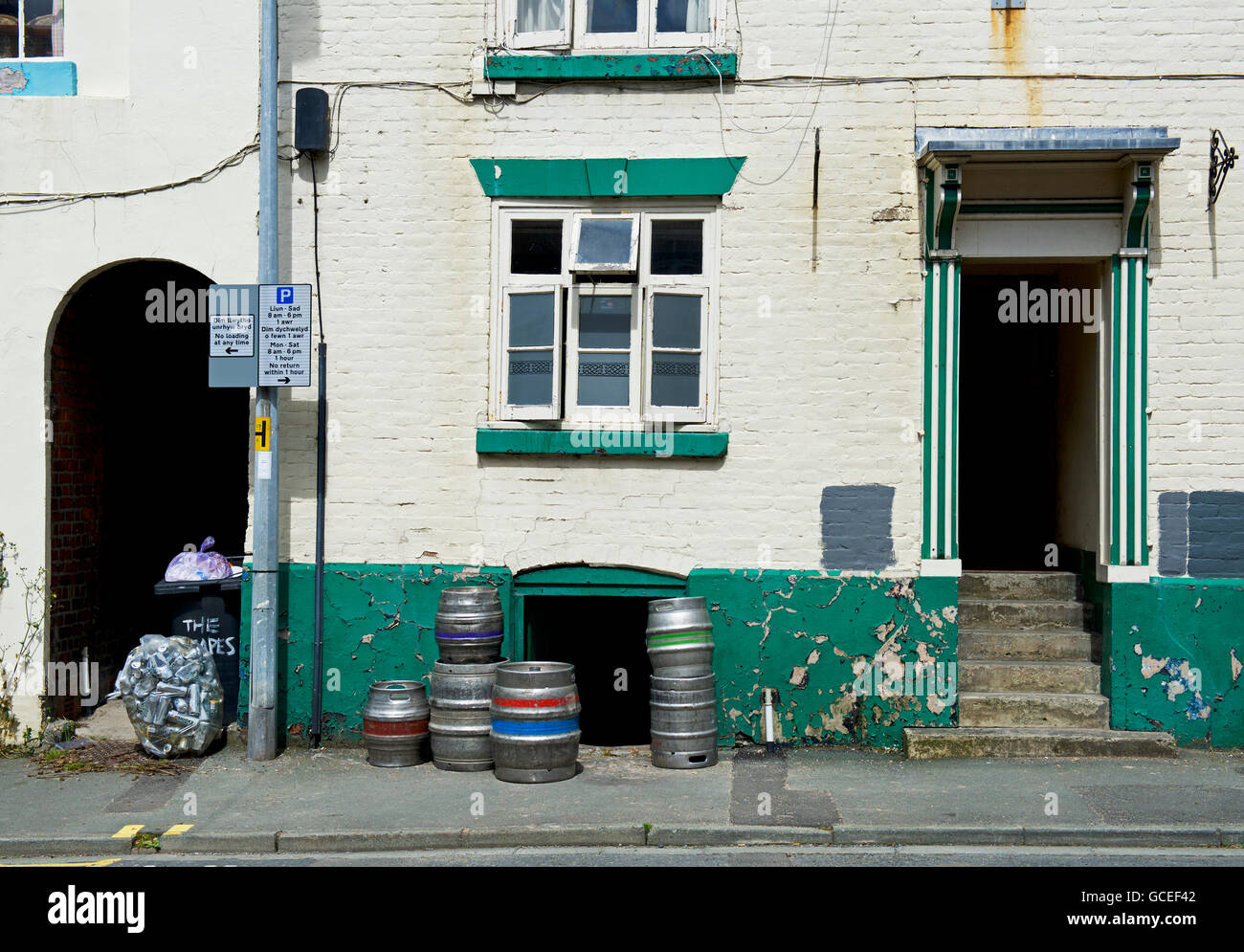 Pub door with beer barrel piled up outside, Newtown, Powys, Wales UK Stock Photo