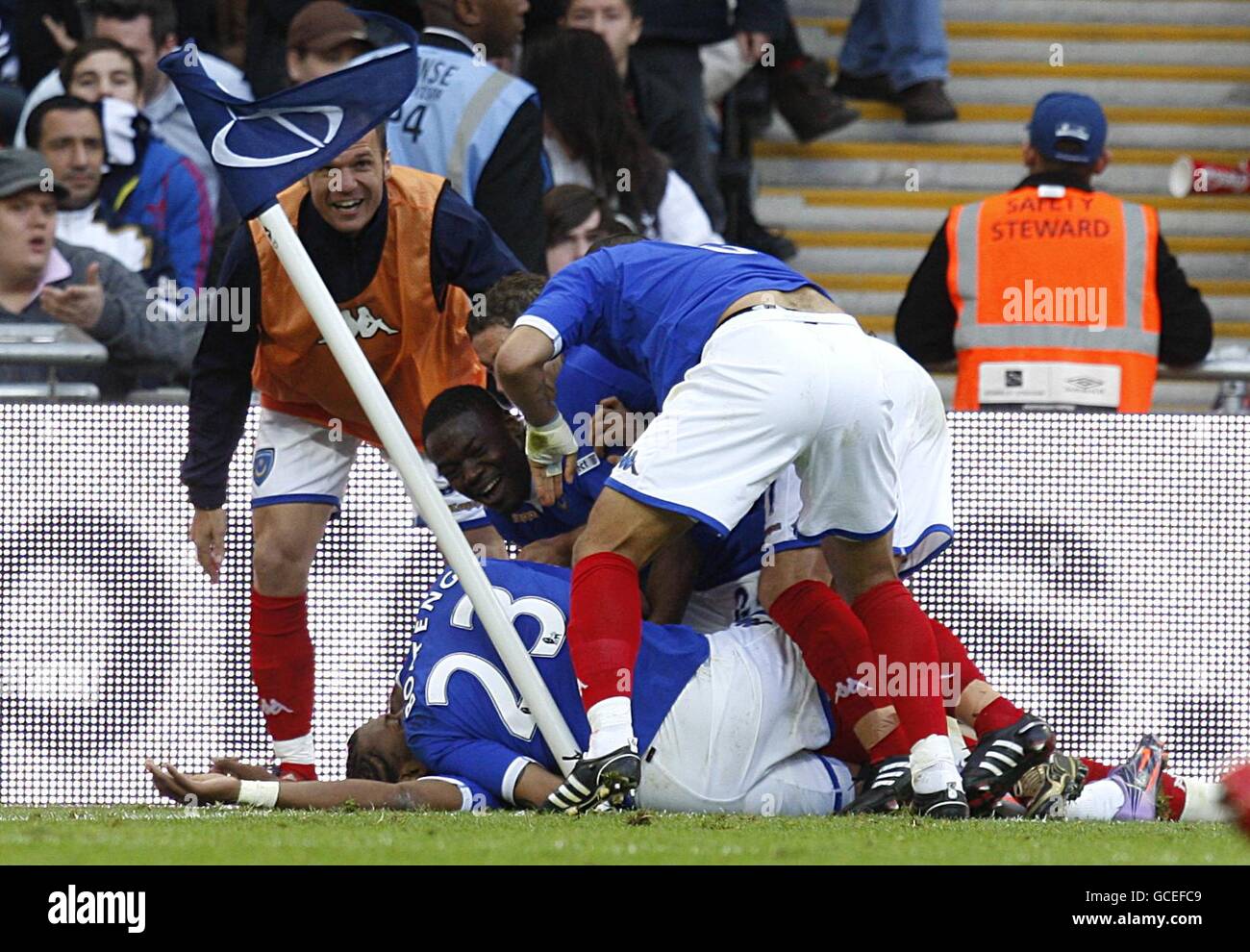 Portsmouth's Frederic Piquionne (hidden) is congratulated by his team mates after scoring the first goal Stock Photo
