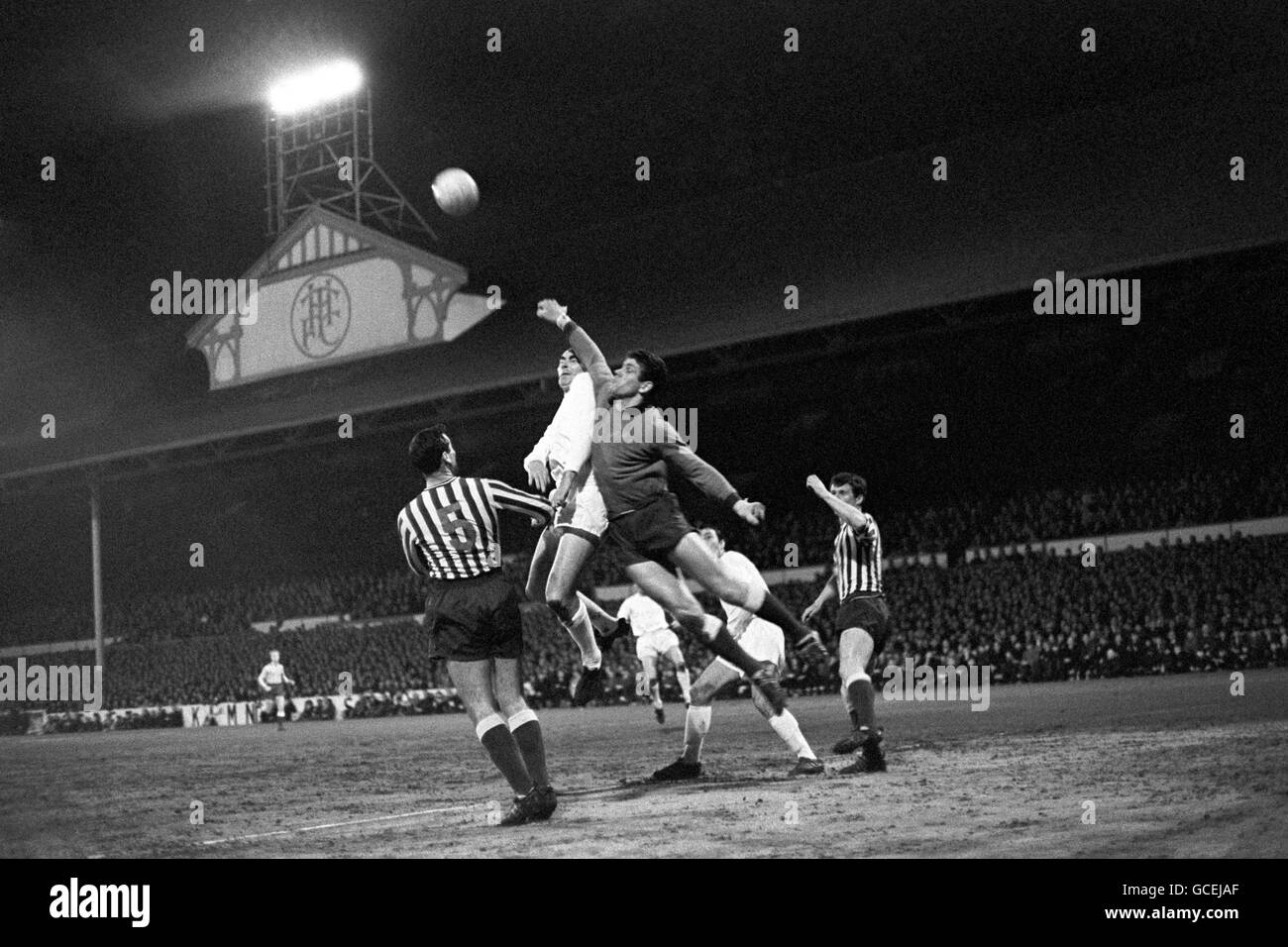 Soccer - FA Cup - Third Round Replay - Tottenham Hotspur v Millwall - White Hart Lane. Millwall goalkeeper Lawrie Leslie leaps high to clear the ball from the head of Spurs' Alan Gilzean. Stock Photo