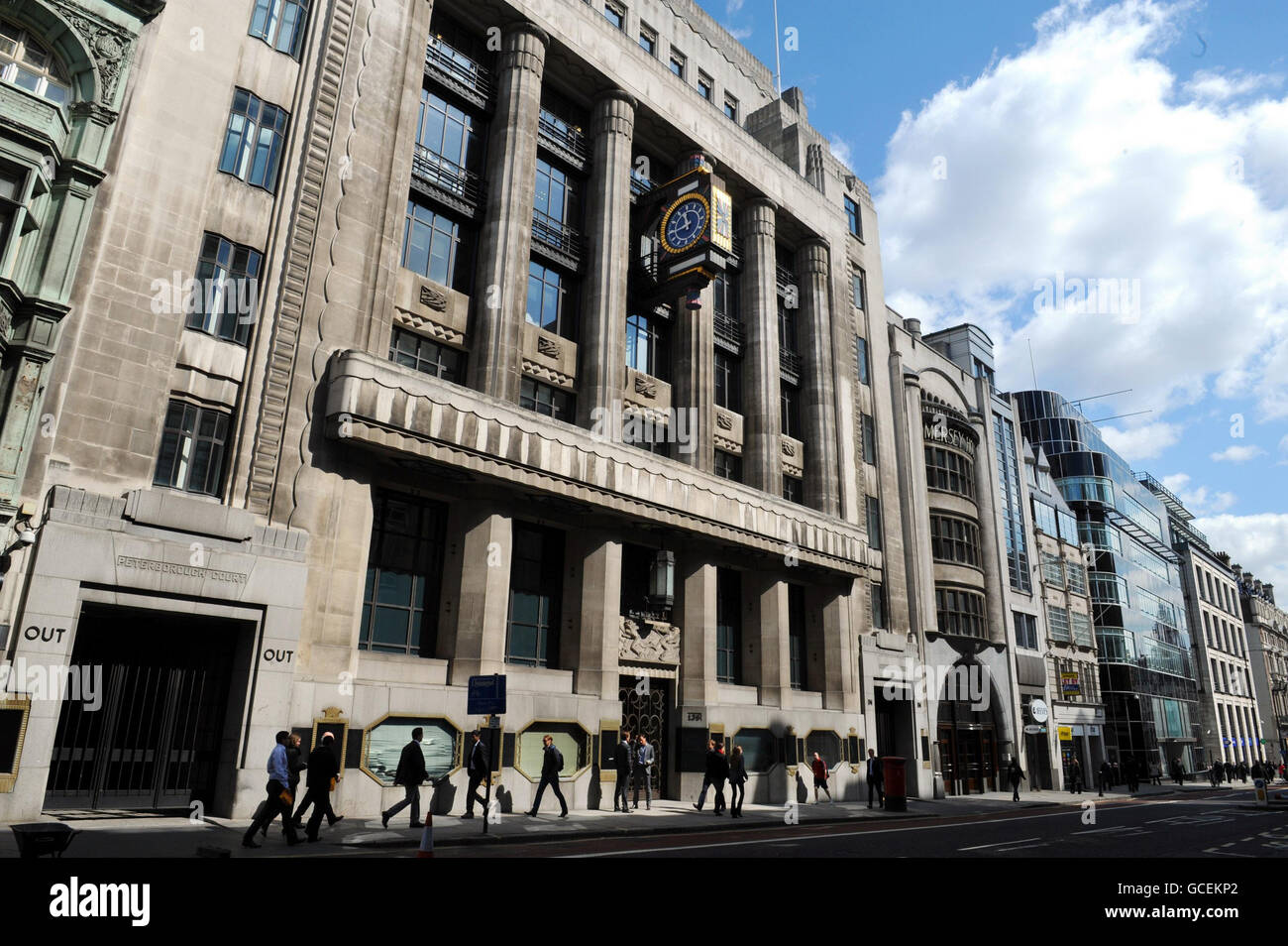 A row of former newspaper office buildings in London's Fleet Street, such as the Daily Telegraph (bearing clock) and the Daily Express (curved glass, Art Deco fascia) which are now all home to the banking house Goldman Sachs. The investment bank has announced a pay and bonus pot of 5.49 billion dollars (3.56 billion) as it posted a steep hike in profits for the first three months of the year. Stock Photo