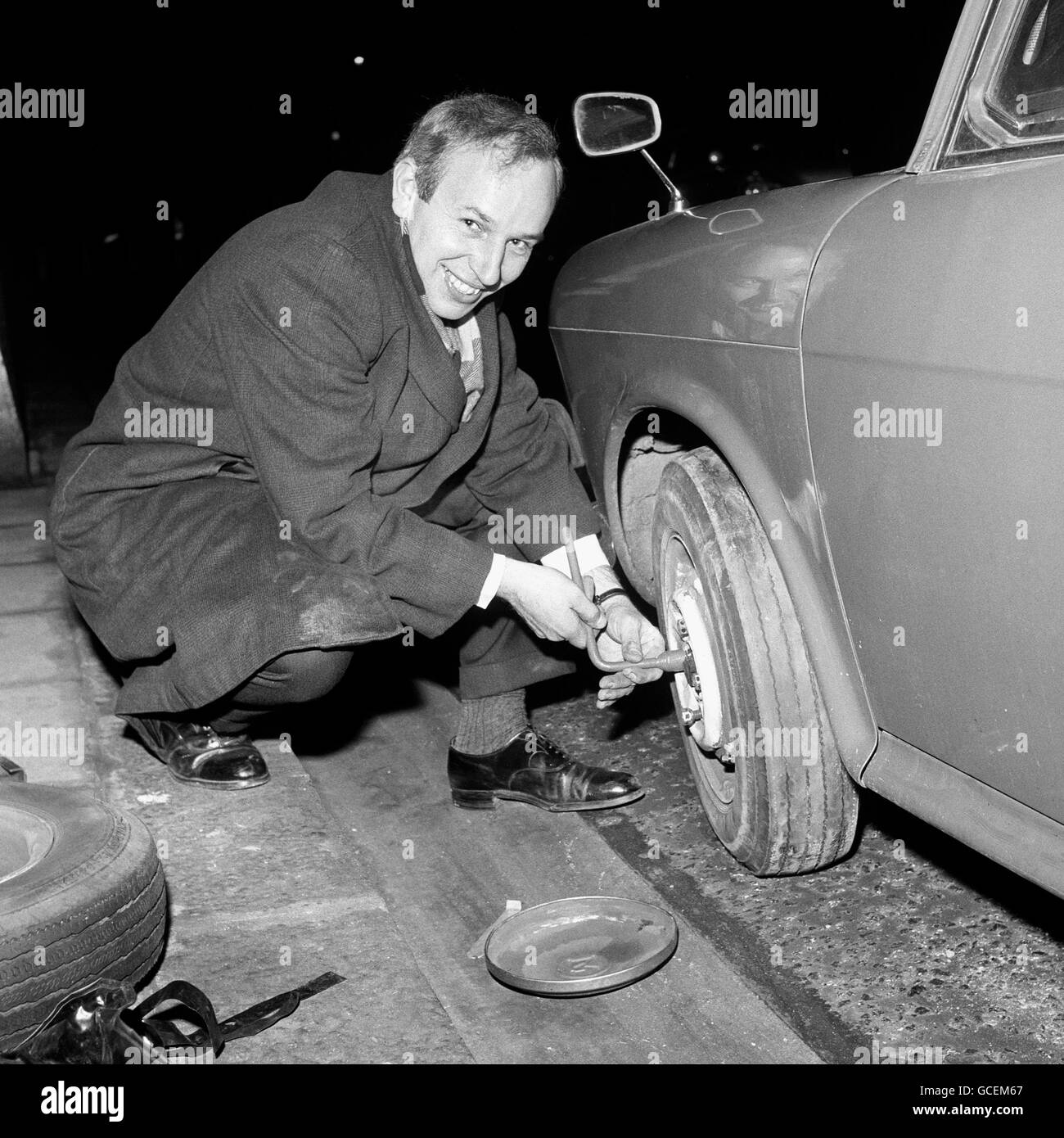 John Surtees stops to change a tyre after getting a puncture. Stock Photo