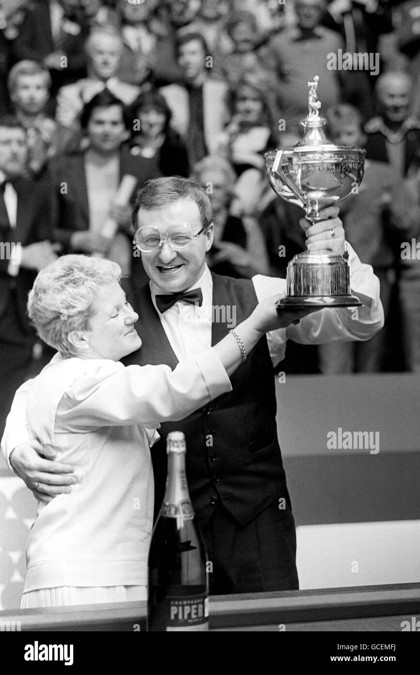 Dennis Taylor, 36, celebrates with his wife Trish, after receiving the Embassy World Professional Snooker Championship Trophy after his dramatic victory over Steve Davis in the early hours of the morning. Stock Photo
