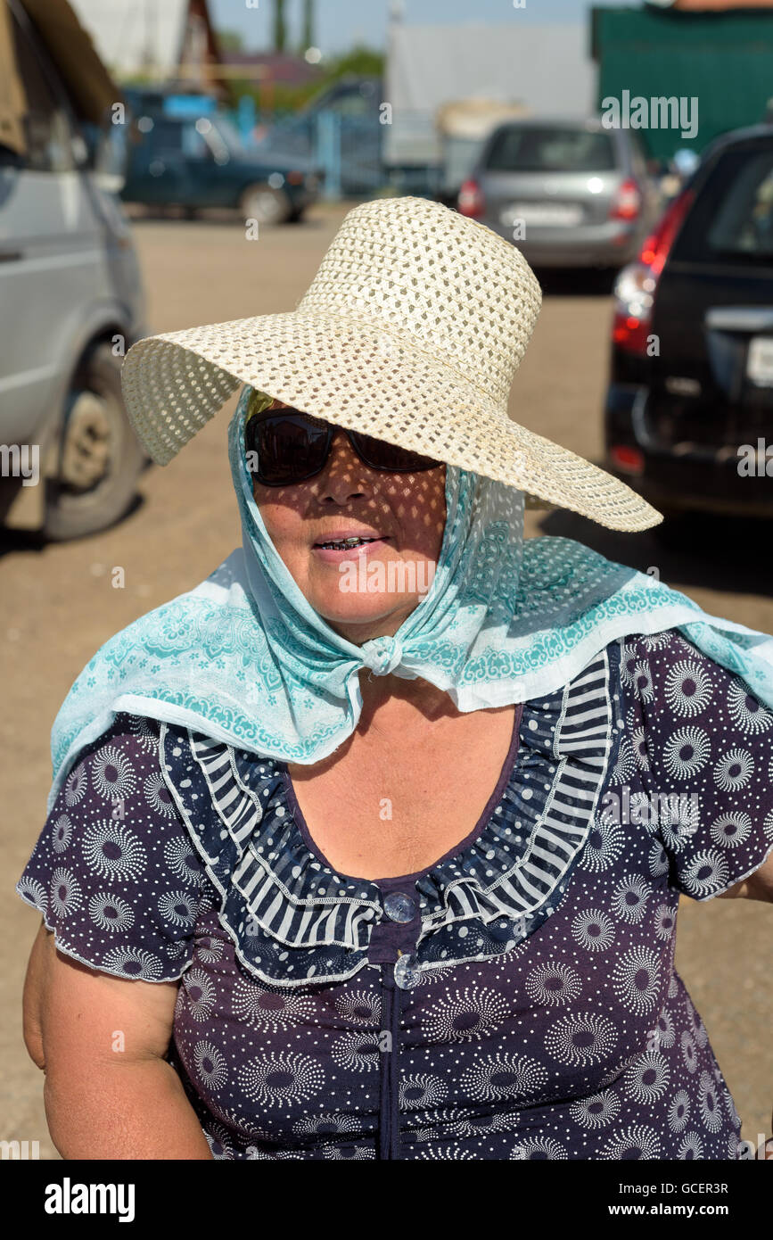 Old woman wearing hat sunglasses hi-res stock photography and