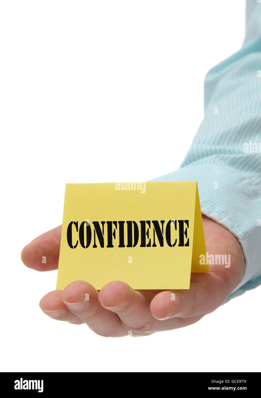 Business man holding yellow confidence sign on hand Stock Photo