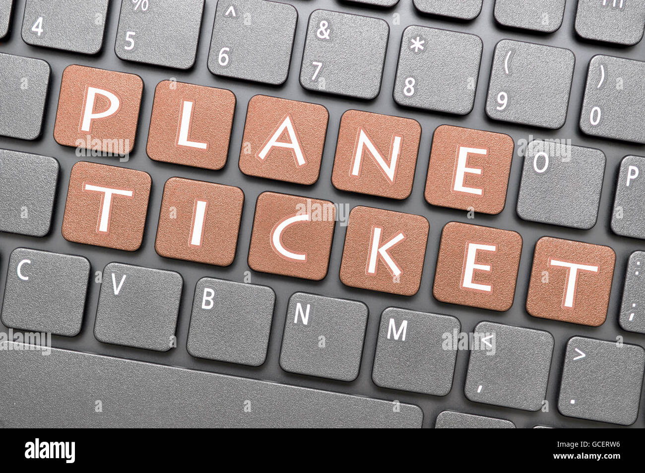 Gunmetal plane ticket key on keyboard Stock Photo