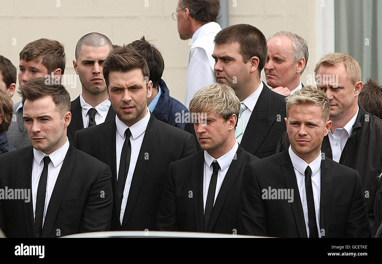 Members of Westlife (left to right) Shane Filan, Mark Feehily, Kian Egan and Nicky Byrne during the funeral of broadcaster Gerry Ryan at St.John the Baptist church in Clontarf, Dublin. Stock Photo