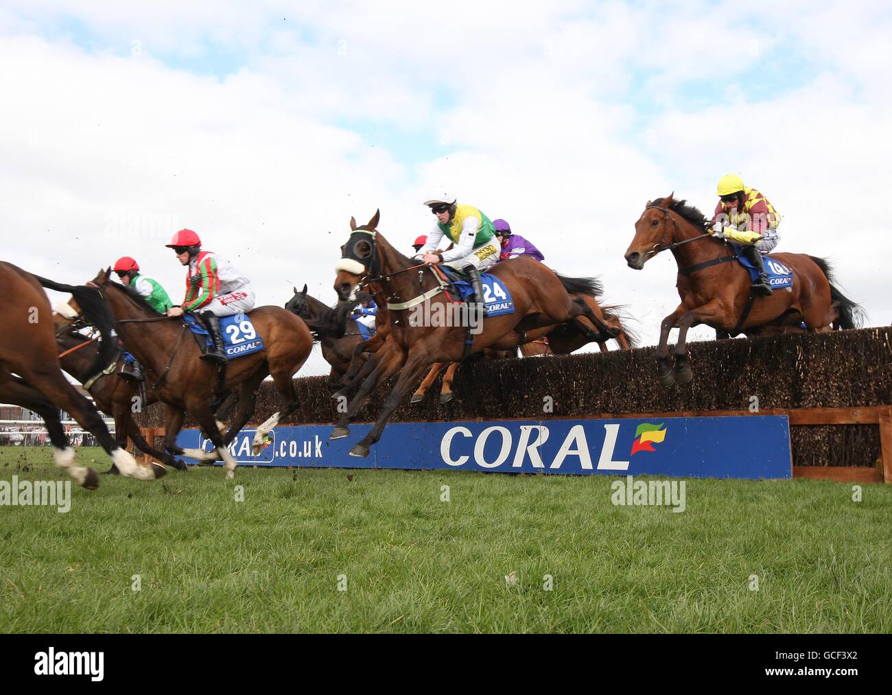 Runners and riders jump during The Coral Scottish Grand National Handicap Steeple Chase during the Coral Scottish Grand National Festival at Ayr Racecourse, Ayr. Stock Photo