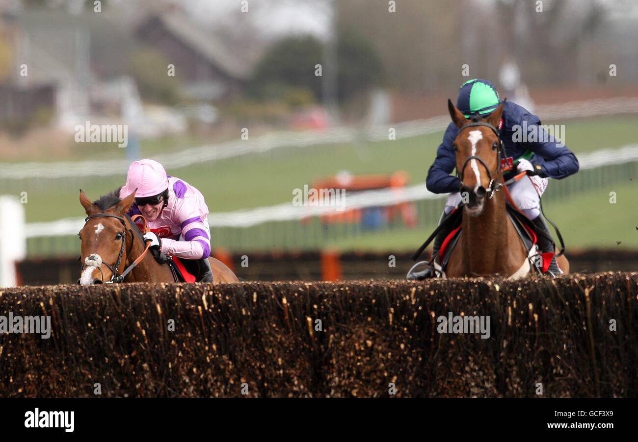 French Opera ridden by Barry Geraghty (right) goes past Tchico Polos ridden by Tony McCoy (left) to go on to win The Scottish Sun Future Champion Novices' Steeple Chase during the Coral Scottish Grand National Festival at Ayr Racecourse, Ayr. Stock Photo