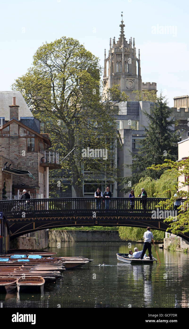 A punt makes its way under Magdalene Bridge on the river Cam in the centre of Cambridge, as people across the UK bask in the spring sunshine. Stock Photo