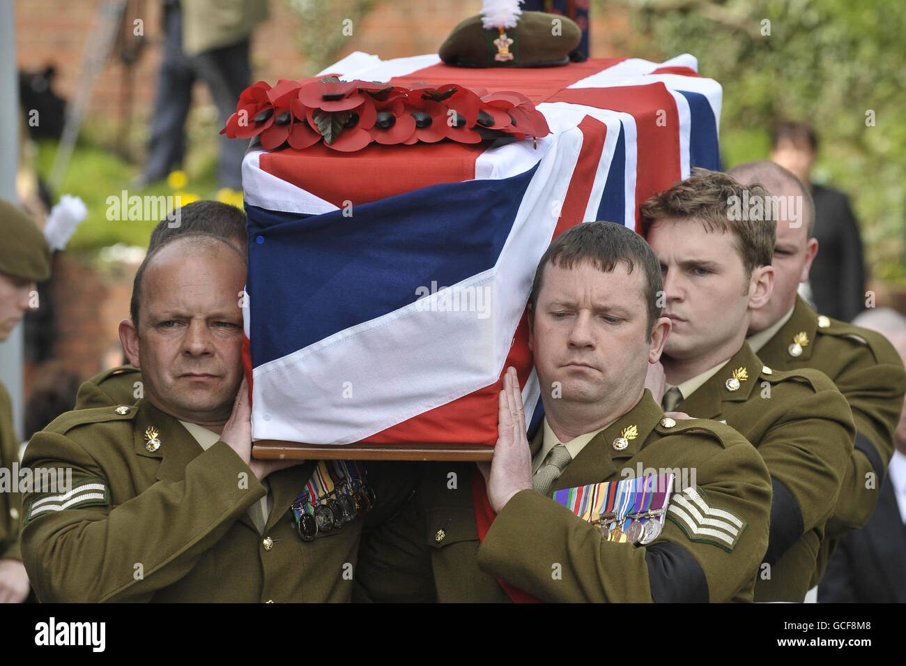 The Union flag draped coffin of Fusilier Jonathan Burgess, 20, is carried into the Cathedral Church of St Joseph, Swansea for his funeral. Stock Photo