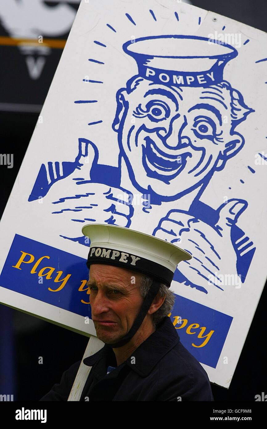 The Portsmouth mascot holds a sign that says 'Play Up Pompey'prior to kick off. Stock Photo