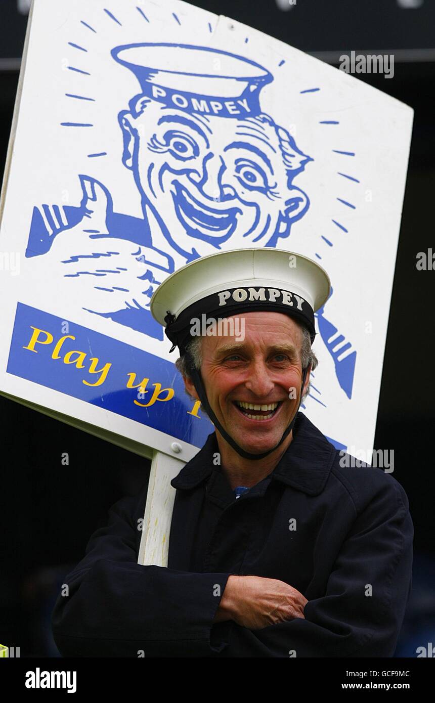 The Portsmouth mascot holds a sign that says 'Play Up Pompey' prior to kick off. Stock Photo