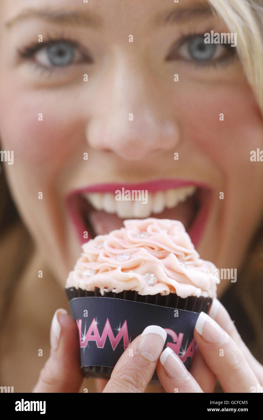 Model Lorna Keir holds a cup Cake worth 100,000 during a photocall at Rox in Glasgow to promote female consumer event Glam. Stock Photo