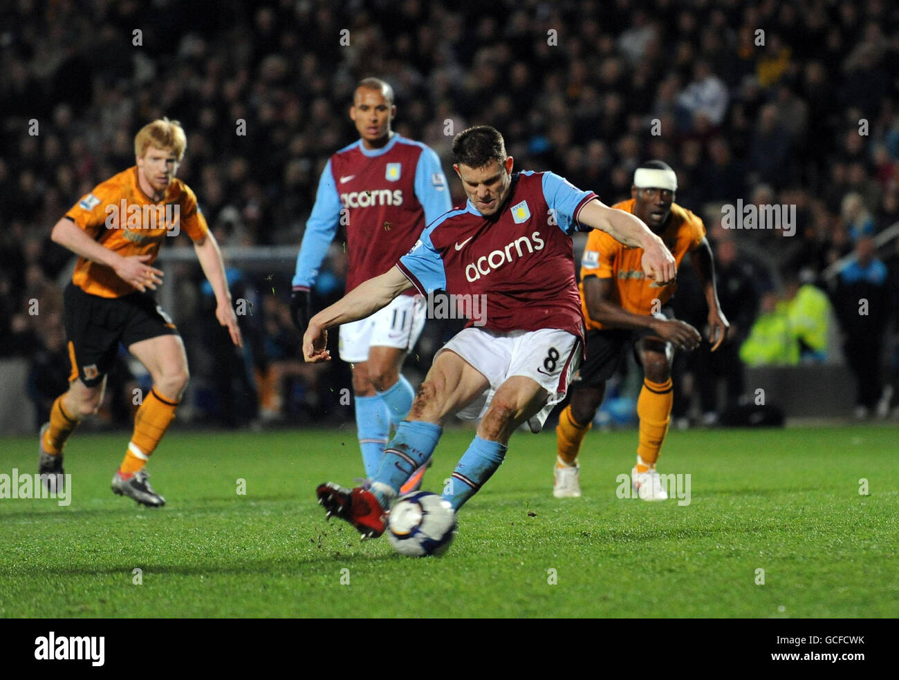 Aston Villa's James Milner scores their second goal from the penalty spot during the Barclays Premier League match at the KC Stadium, Hull. Stock Photo