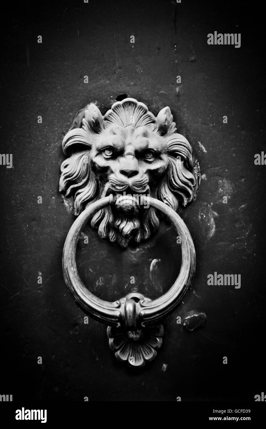 ancient door knocker with a lion's head with mouth open Stock Photo