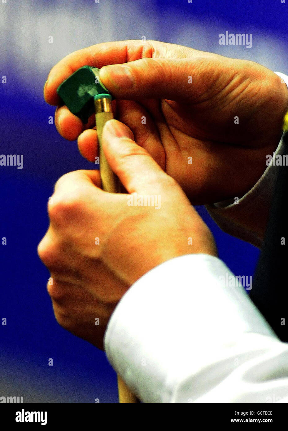 Close up player chalking cue world snooker championships crucible