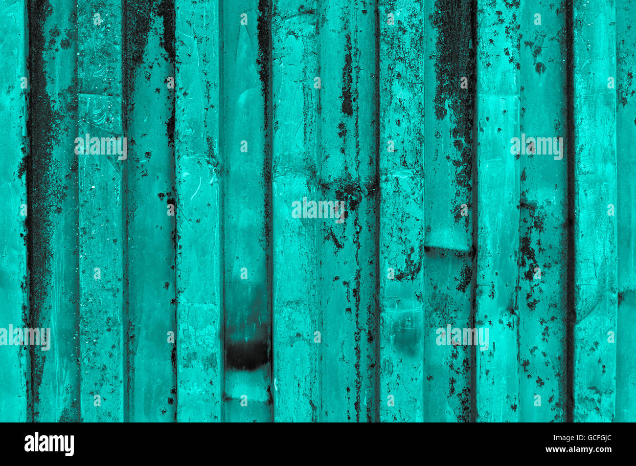 rough and rusty turquoise grayish grayscale corrugated iron metal surface close-up Stock Photo