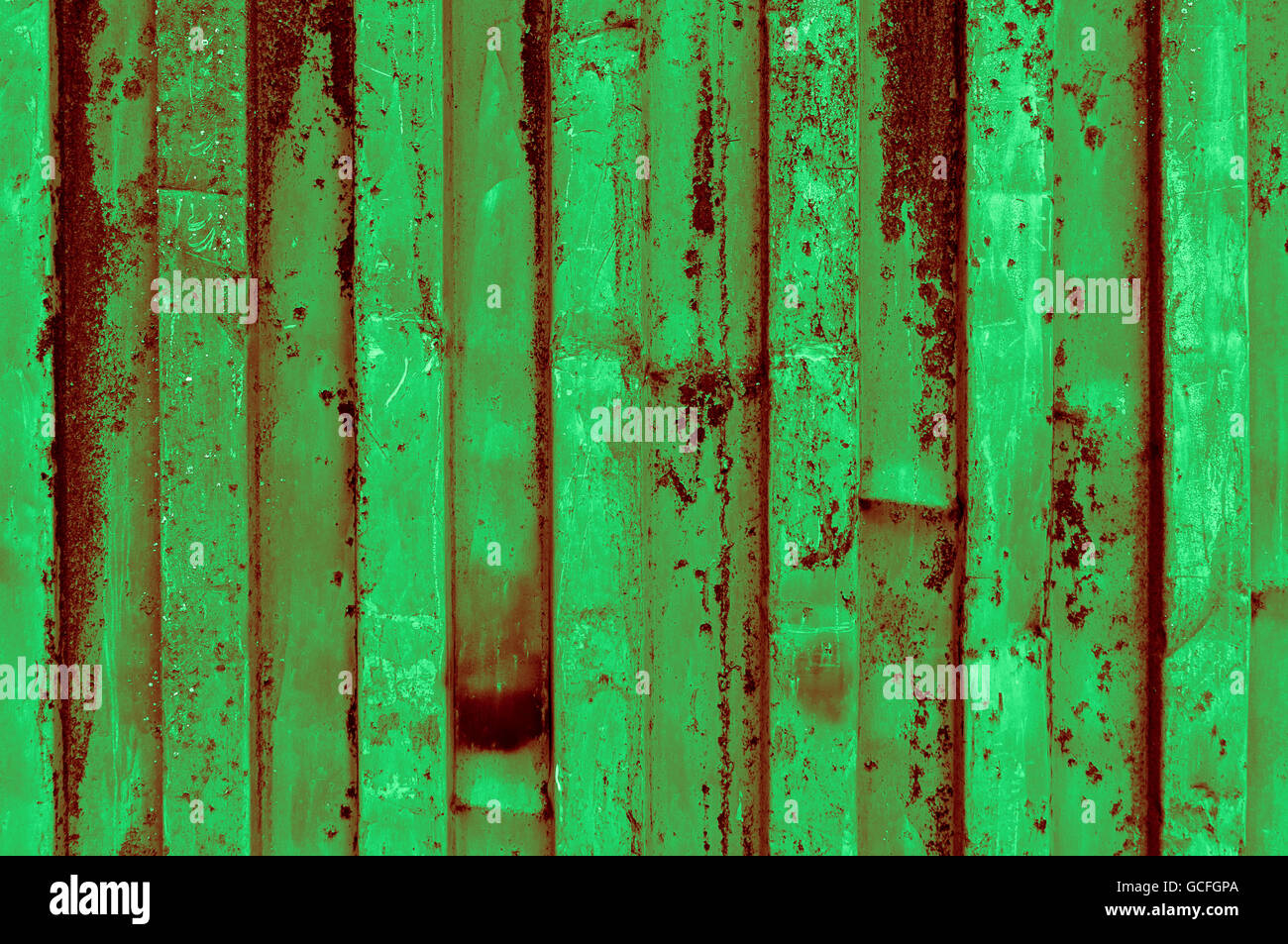 rough and rusty light dark green reddish greenish corrugated iron metal surface close-up Stock Photo