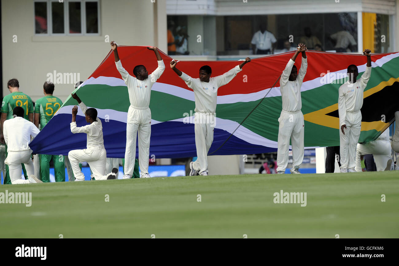 Local schoolchildren hold the South African flag before the start of the Super Eights match at Beausejour Stadium, St Lucia. Stock Photo
